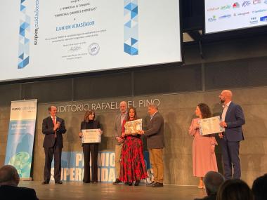 El director del Centros e Infraestructura, Rafael Linares, y la  directora del área de Centros Residenciales, Zoraida Martínez, posan en el escenario con el premio