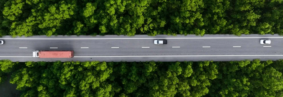 Foto carretera con vehículos con zonas verdes.