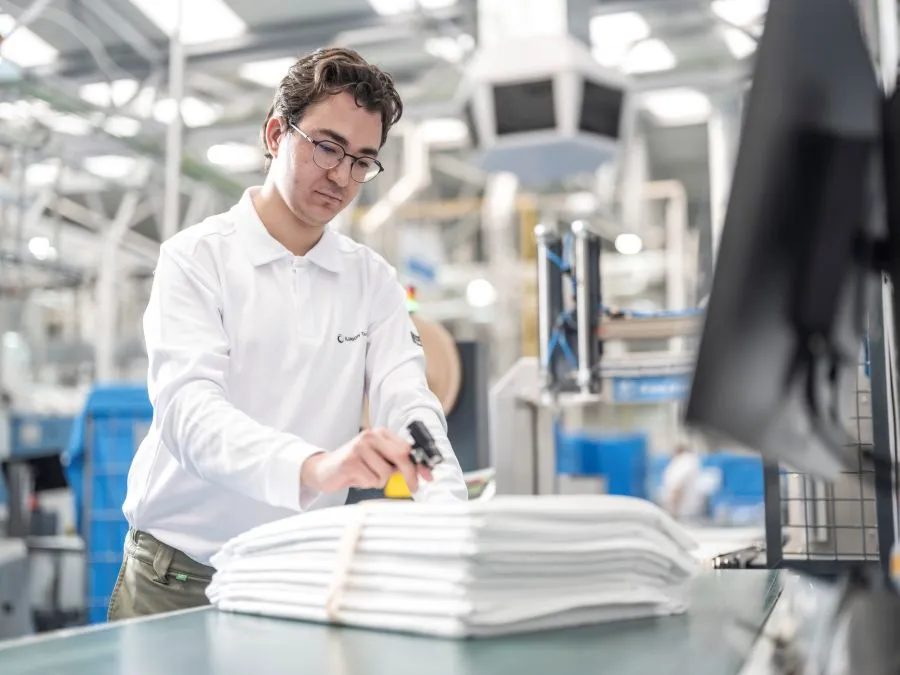 Operario de lavandería manipulando una tecnología para hacer uso de las etiquetas RFID