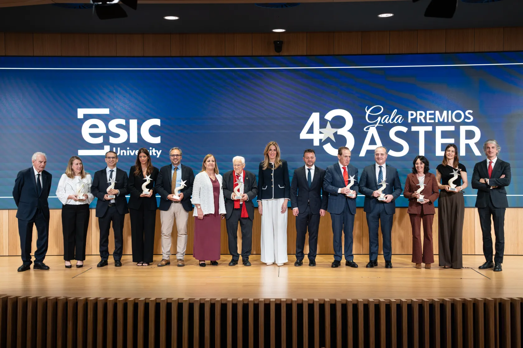 Grupo de personas premiadas en el escenario de ESIC University durante la 43 Gala Premios ASTER.