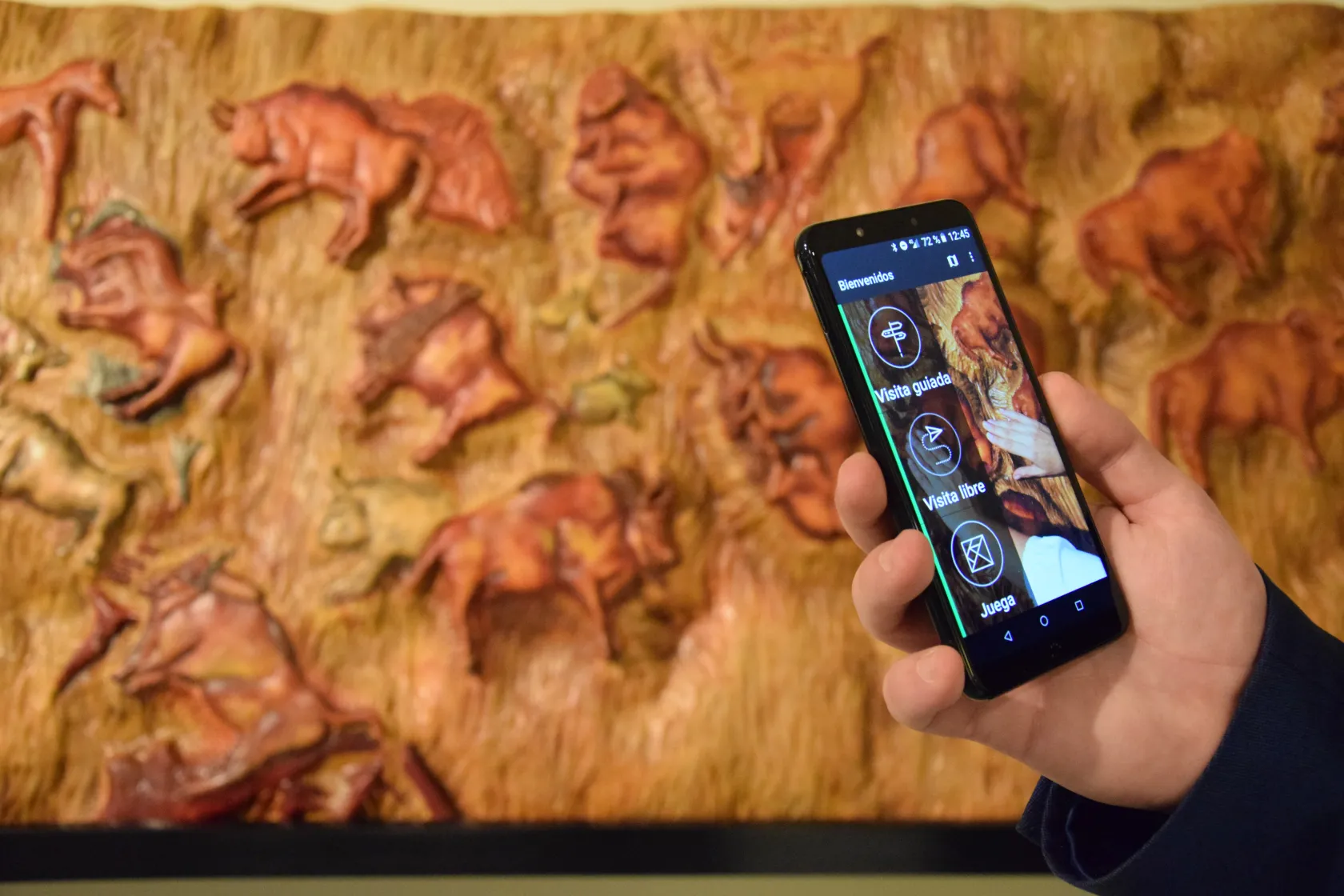 Fotografía en la que aparece la aplicación Amuse y una reproducción de las cuevas de Altamira