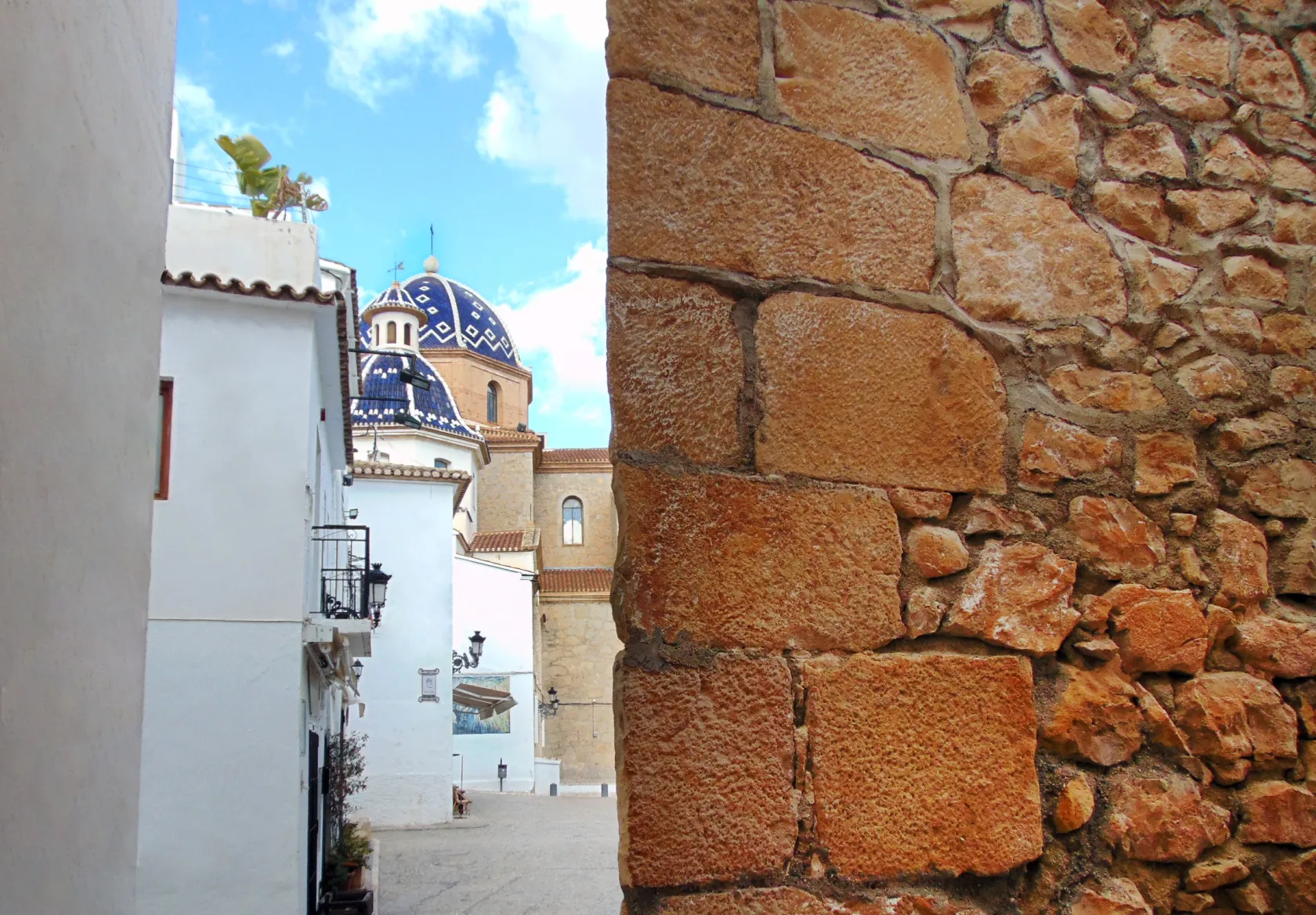 Parte de la muralla de Altea con la Iglesia de Nuestra Señora del Consuelo al fondo. 