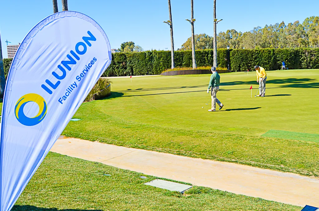Fotografía de un campo de golf en el que aparece un cartel de ILUNION Facility Services 
