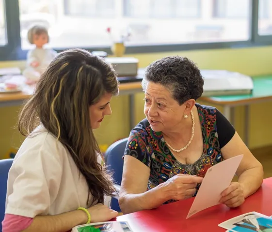 Terapeuta ocupacional de ILUNION atiende a una persona mayor 