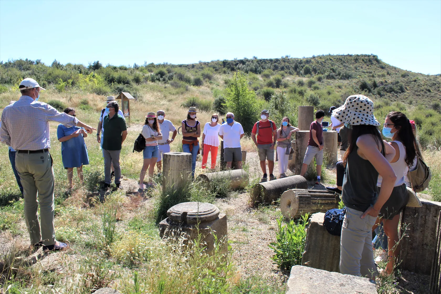Visita guiada a Santa Criz de Eslava. Un grupo de personas, ataviadas con mascarillas, visitan una parte del yacimiento. 